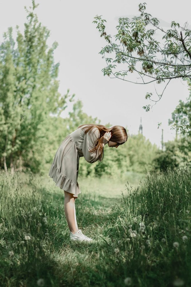 side view of a woman looking at the grass