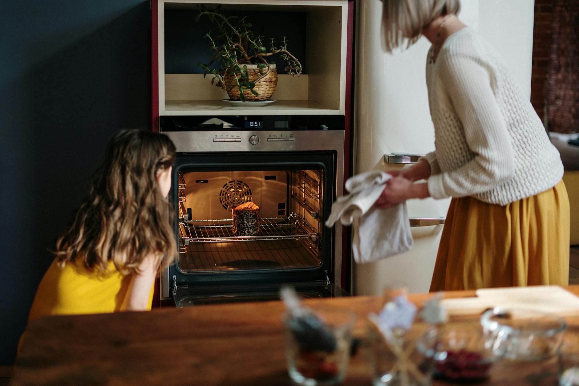 mom and daughter baking a cake